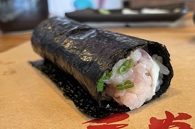 A yellowtail hand roll, made to be eaten fresh, and crispy, with still-warm rice