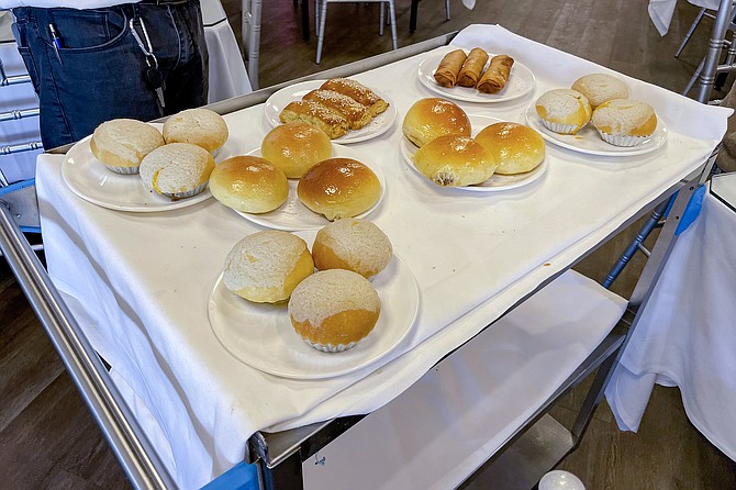 A dim sum cart parades small plates among tables