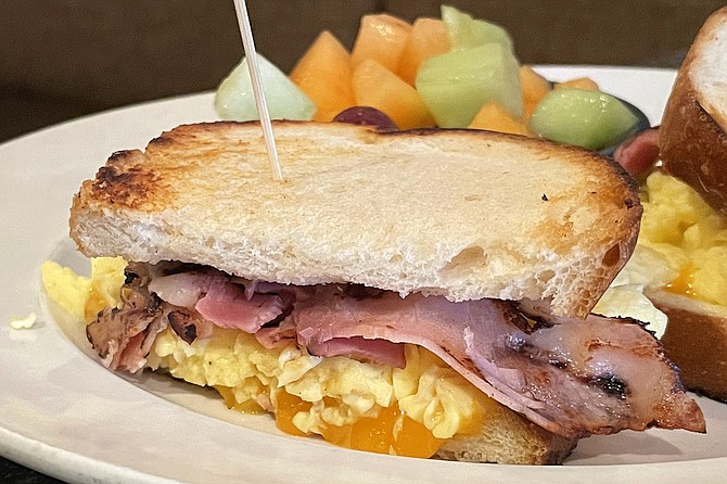 Breakfast sandwich on sourdough toast, with ham and scrambled eggs