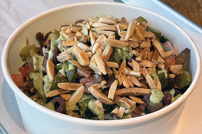 A build-your-own 50/50 bowl: featuring both steak and chicken shawarma, with both salad greens and yellow basmati rice