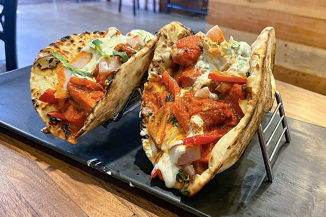 Tikka naan "tacos" of chicken tikka masala served on naan flatbread