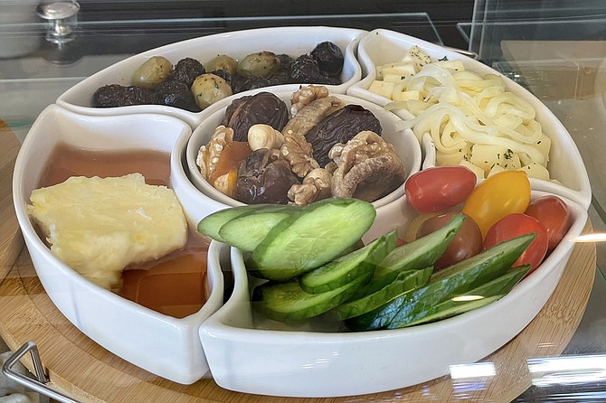 A Turkish breakfast, featuring clotted cream and honey, olives, walnuts, and dried fruits