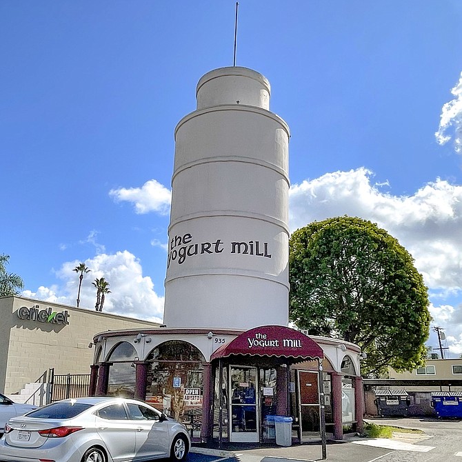 A yogurt shop inside a storefront originally built for a restaurant likely called The Leaning Tower of Pizza