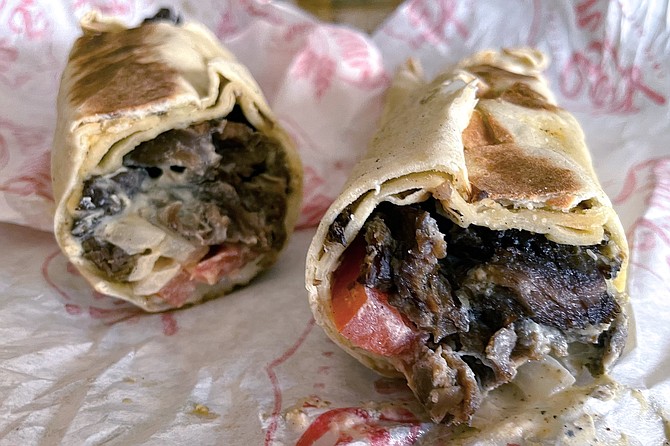 A foot-long beef shawarma wrap, rolled in a fresh saj flatbread