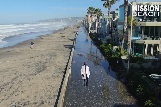 A cheerful scientist studies the effects of climate change on sea level rise in front of his new Mission Beach condo.