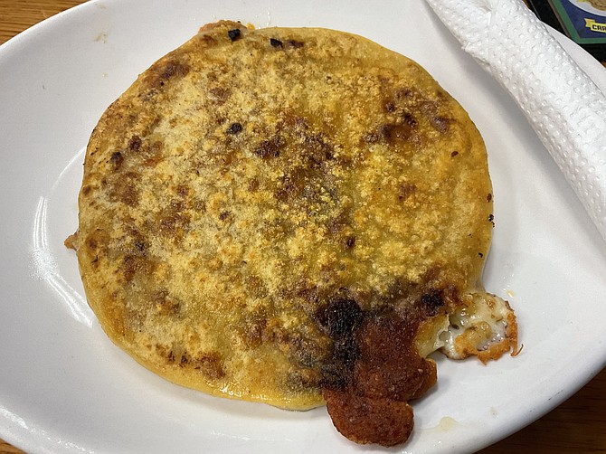 Revuelta pupusa is a savory masterpiece of pork, beans, and much more.