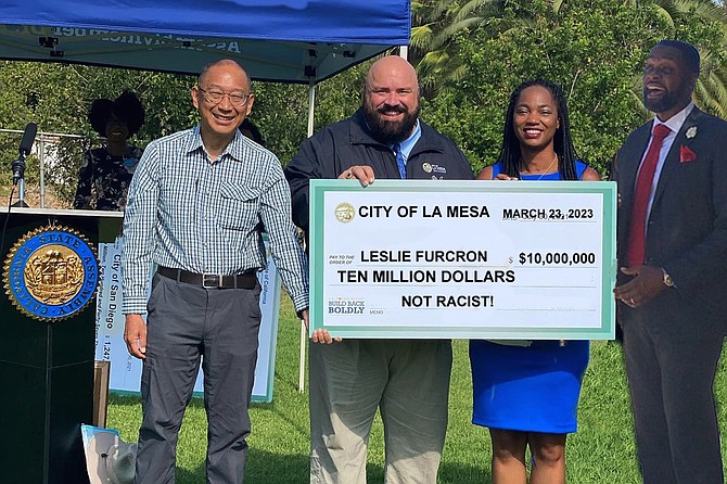La Mesa Mayor Mark Arapostathis presents Leslie Furcron’s attorney Dante Pride with a very large check. “Our officer may not have done anything wrong,” he said during the ceremony, “but we hope this makes it right. Next time a large crowd of angry protestors comes to our town, surrounds our government buildings, and starts throwing rocks and bottles, I promise that no police officer will shoot anyone in the head with a bean bag. Mostly because this $10 million had to come out of our public safety budget, and so we just don’t have the manpower for that sort of thing. But also because we are definitely not racist!”