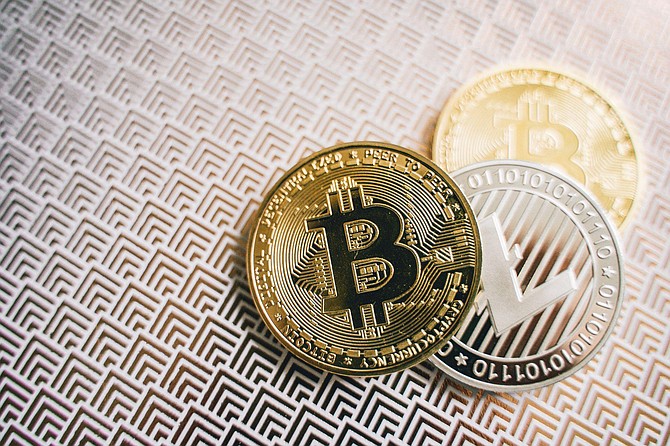 SPONSORED CONTENT 3 crypto coins on the table.