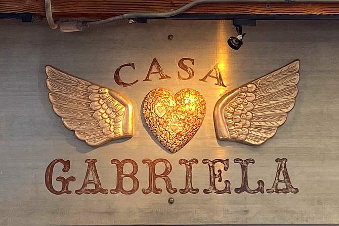 Hearts — either winged or flaming — provide a unifying decorative element to the space.