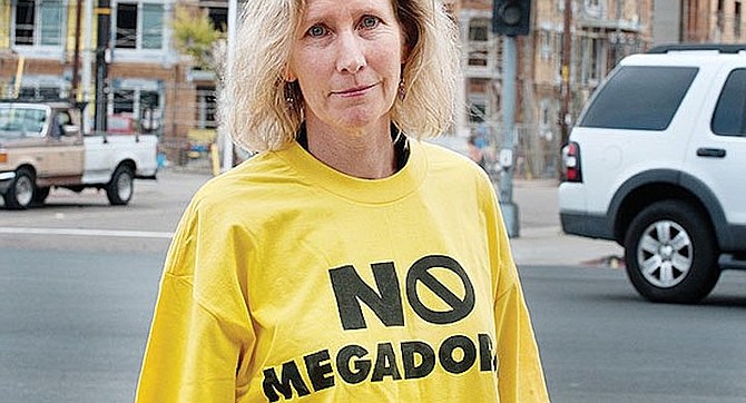 “No Megadorms,” reads the Karen Collins T-shirt, who warns, “This single development will add 50 percent to Rolando’s population.”