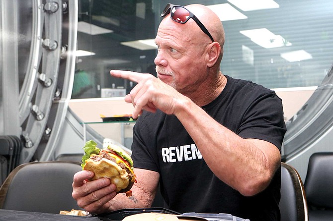 Jim McMahon eating a THC-infused hamburger from Mint Cannabis.