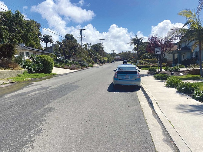 On the southernmost block of Monroe Street in Carlsbad, only the four newer tract homes on the west side of the street have sidewalks, while the two other houses, and all six on the east side of the street, do not.