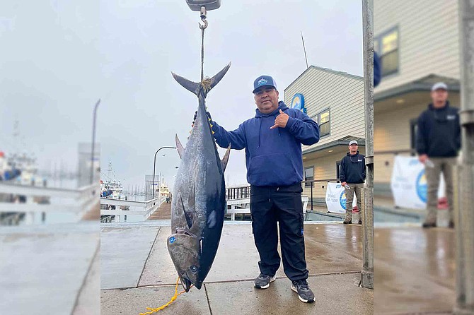 Antonio Rosales with his 142.2-pound jackpot winning bluefin caught aboard the Intrepid using a knife jig.