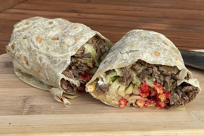 A glimpse inside a Flamin' Hot Cheetos California burrito