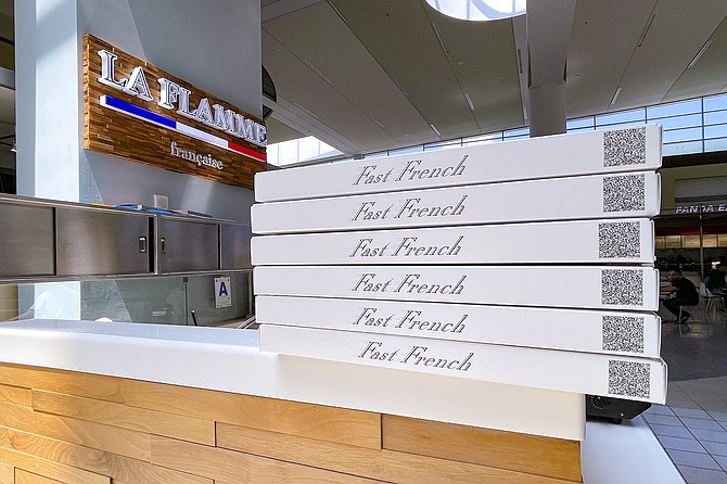 A food court counter serving "Fast French" food
