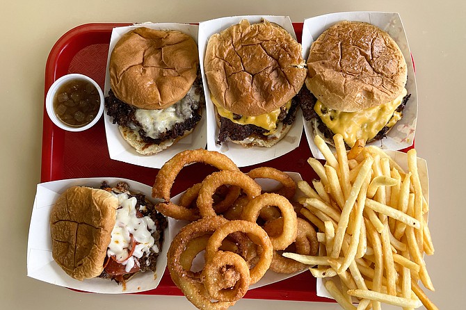 From bottom left: pizza burger, French onion dip burger, and two OG Dirty Flat Top burgers