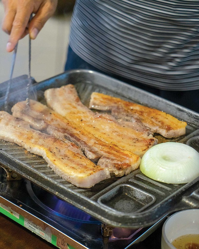 The pork belly at Choga was grilled at our table with onions, jalapeños, and garlic.