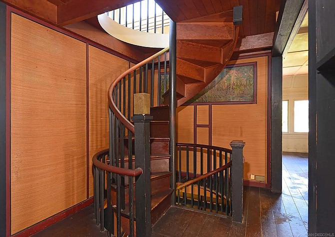 A spiral staircase leads up to an open landing.