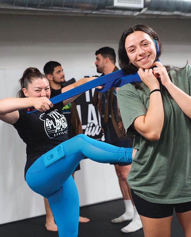 Dawna Gonzalez giving a belt promotion. Gonzalez runs women’s Jiu-Jitsu and self-defense classes at 10th Planet South Bay.