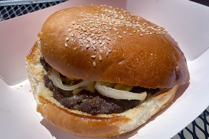 An Al-Jadriya burger, with grilled tomatoes and onions