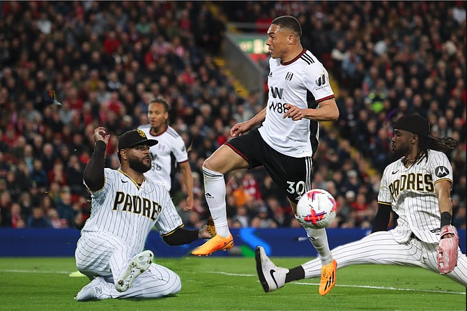 Sliding skills, from “safe” to “save”: The Padres’ Pedro Avila and Fernando Tatis, Jr. expertly break up a run on goal by Fulham FC’s Carlos Vinicius in a recent friendly.