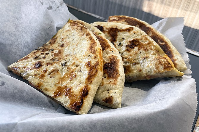 Badami naan: flatbread stuffed with crushed almonds, cashews, and peanuts, plus fennel seeds and diced cherries