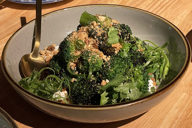 Charred broccoli with yuzu ponzu, crushed peanuts, chili crunch sauce, and labneh