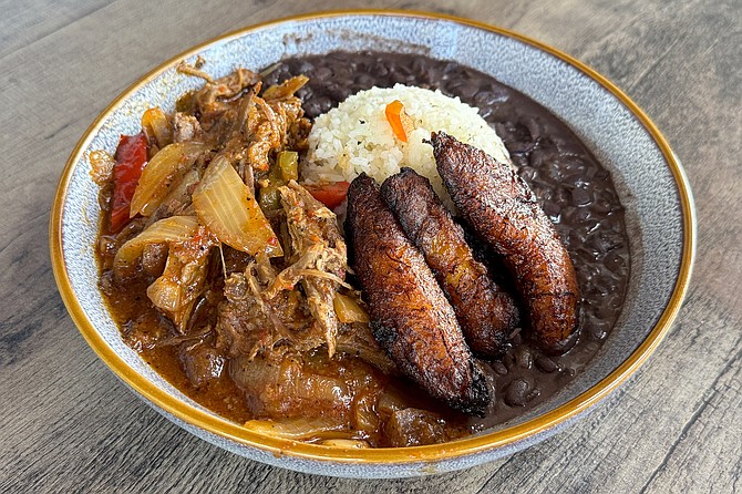 Ropa vieja. a dish of shredded beef, stewed in a Cuban sofrito of tomatoes, onions, bell peppers, and wine