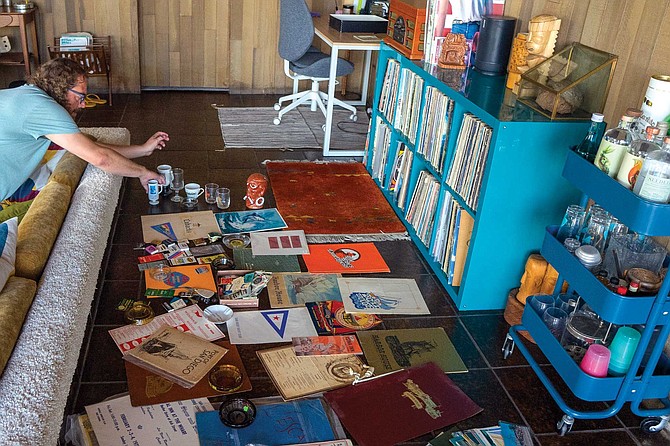 Adam Meyer arranges items from his San Diego Bay collection. “I’ve got 30 or 40 matchbooks for restaurants and other businesses that used to be on the Bay,” he says, “along with menus and ashtrays.”