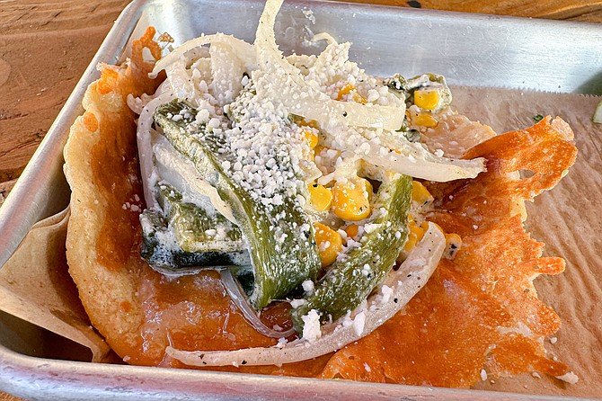 A rajas taco, featuring poblano peppers, onions, and corn
