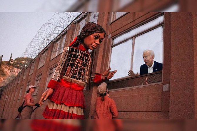 A terrified President Biden struggled to contain his panic as he greets “Little Amal” through the border fence outside Tijuana. “What do you mean, ‘little’?” he asked. “She’s huge! If we don’t destroy her before he reaches adulthood, our defenses will be useless!”