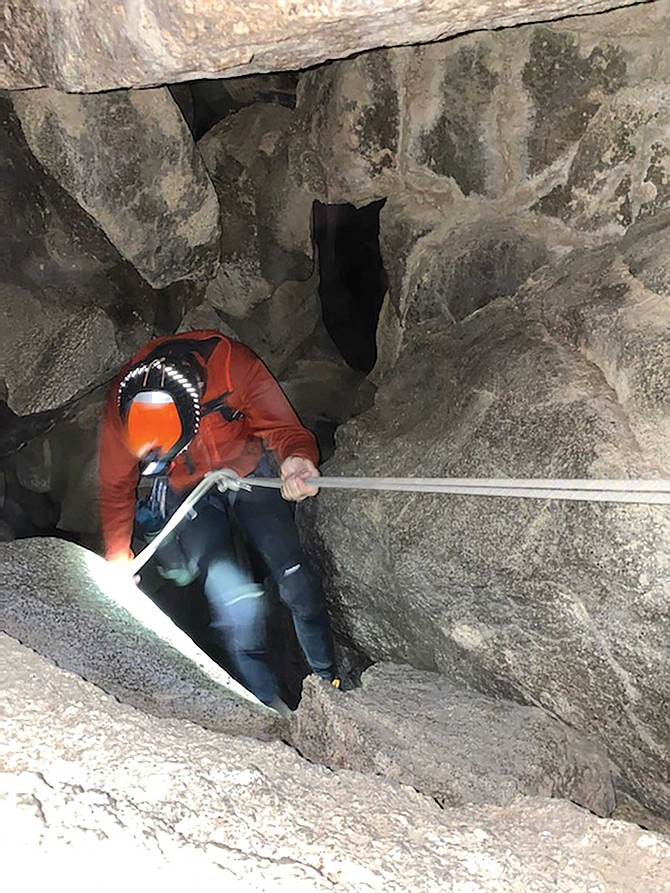 You don’t take a first step into Thunder Canyon Cave. You make a first descent, hanging onto a rope. As I lower myself down, I can hear the water roaring below.