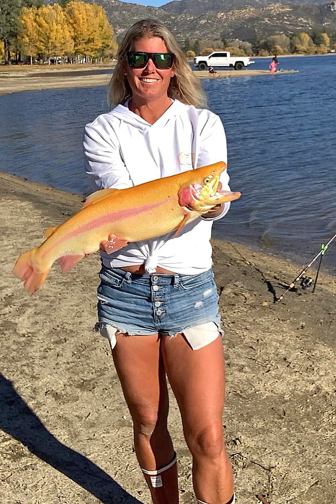 Temecula fishing guru and content creator Tracy Hartman with a fat lightning trout caught just north of San Diego County at Lake Hemet.