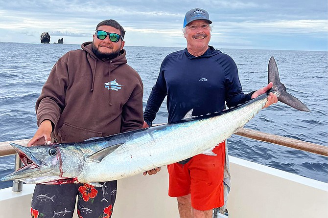 Happy anglers with a good-sized wahoo caught while fishing aboard the Intrepid near Alijos Rocks off Baja Sur.