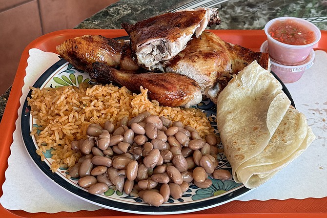 A half chicken "Special C" from El Pollo Grill, with rice, beans, and warm flour tortillas for $15.99.