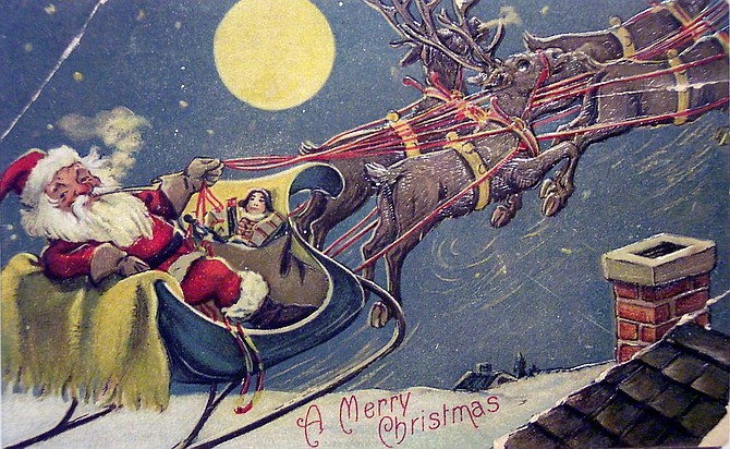 A vintage Christmas card shows Santa delivering gifts under a full moon.