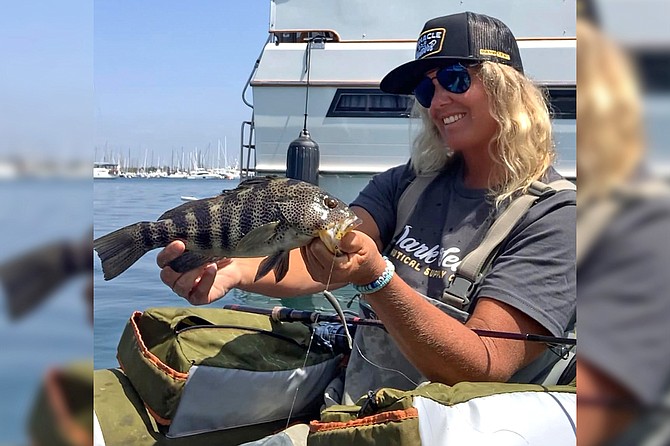 Avid Temecula salt and freshwater angler Tracy Hartman with a nice spotted bay bass caught while float-tube fishing bay structure.