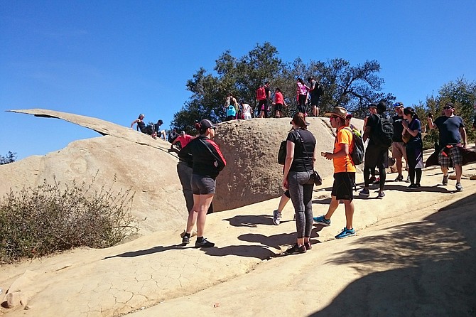 A line of hikers posing with the chip.
