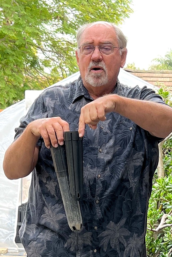 Jim Crouch, seen here with oak seedling pot, is doing the work for his grandkids.