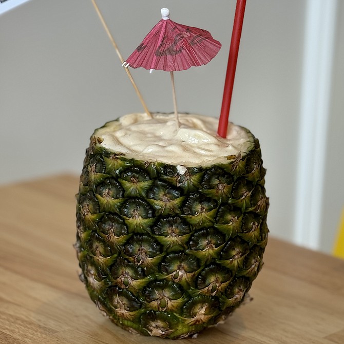 A pineapple smoothie, served inside a pineapple