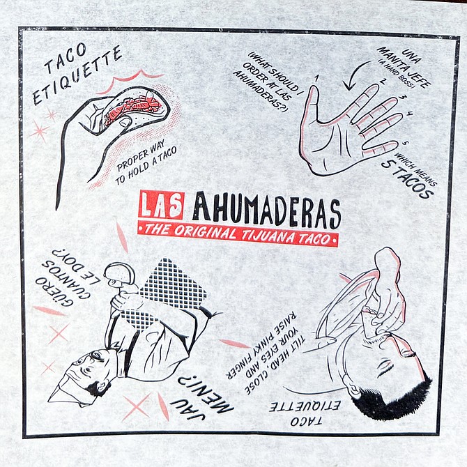 Tacos are wrapped in thin parchment printed with a cheeky cartoon about taco etiquette