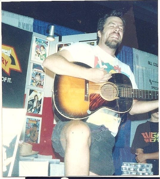 Mojo Nixon performs a surprise set at the Rock 'N' Roll Comics booth at the 1994 San Diego Comic-Con - Image by Jay Allen Sanford