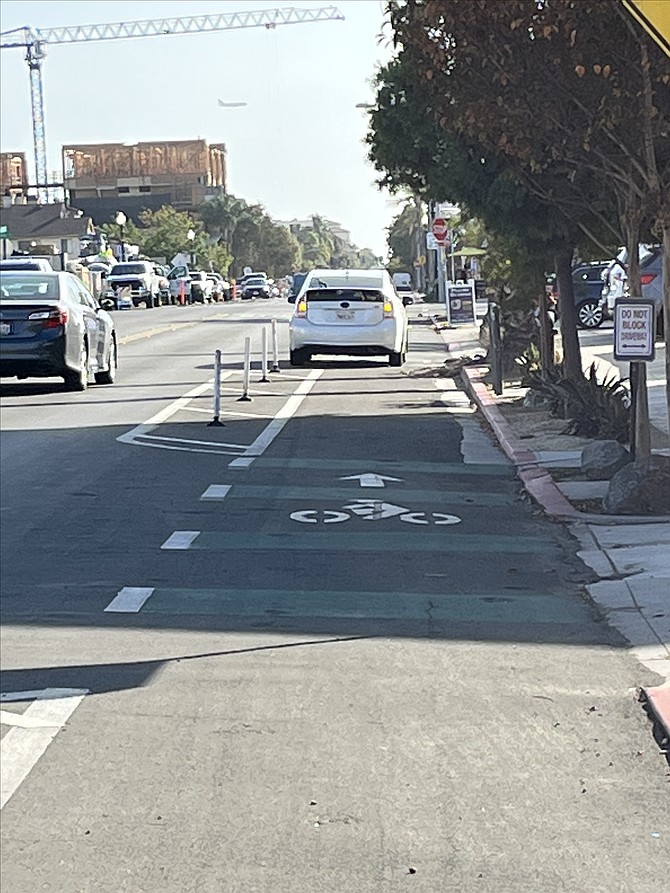 He notices people parked in the bike lanes loading or unloading groceries.