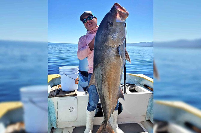 Rigoberto Geraldo Lucero of Tortugas sportfishing with his massive 90-pound amberjack caught while fishing out of Ensenada de Los Muertos.