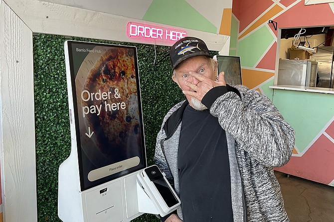 Tim, flummoxed by technological demands, just to order a burger.