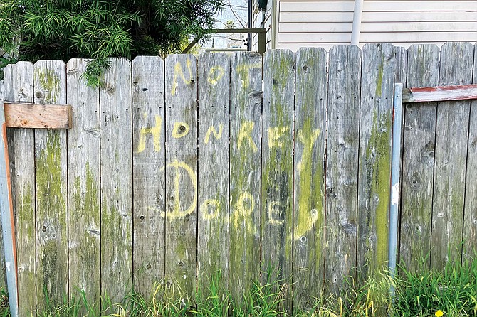 “NOT HONKEY DOREY” written on the fence separating his property from the neighbor’s.