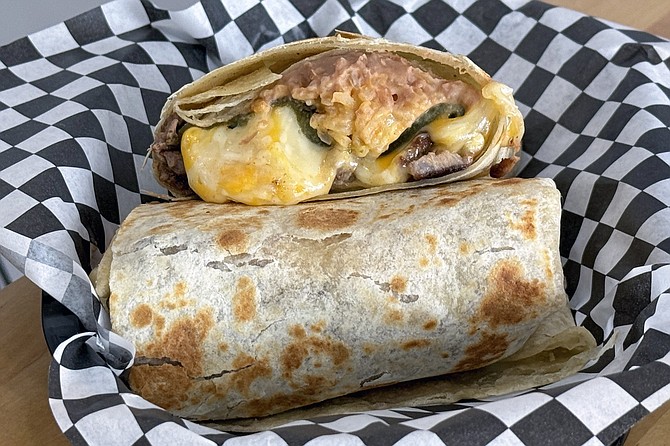 The poblano burrito, featuring carne asada, beans, rice, and a melted-cheese stuffed poblano pepper