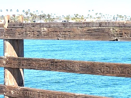Some 5200 names are etched into railing boards along the side of the pier.