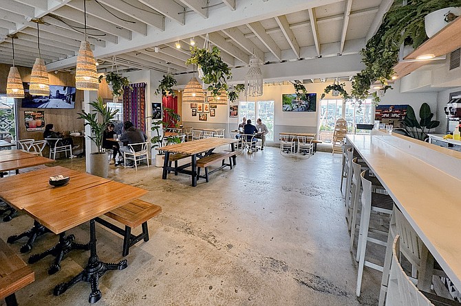 A spacious dining room and back patio at Flama Llama