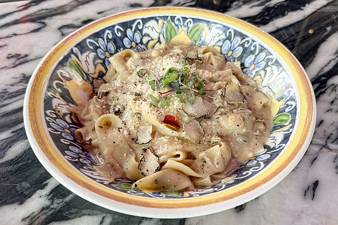 Pecorino and truffle pappardelle, tossed in a Grana Padang cheese wheel